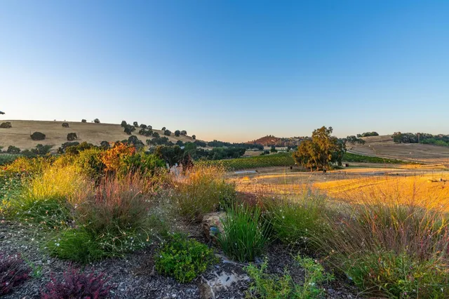 a kitchen with stainless steel appliances granite countertop a stove and a refrigerator