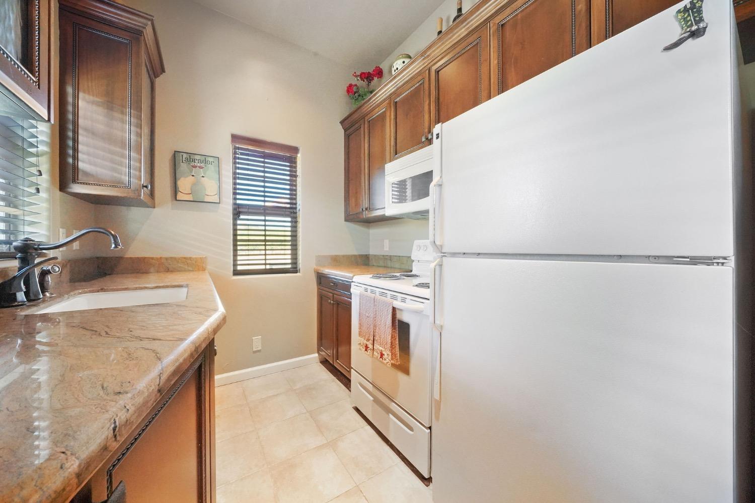 11195 Vintage Road Ione, CA 95640 - Photo 83 of 92 a kitchen with a sink stove and refrigerator