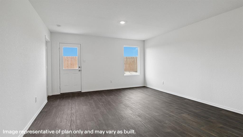 3522 Spring Time Street Forney, TX 75126 - Photo 15 of 27 Spacious room with dark wood-finish flooring, white walls, and bright overhead lighting