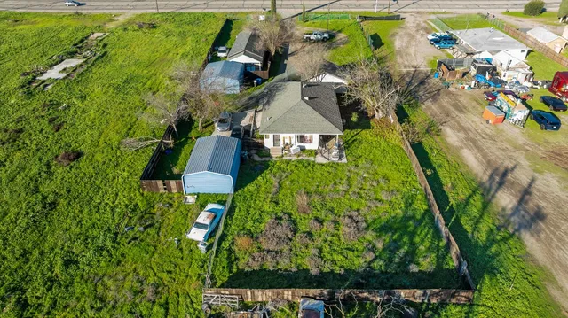 a backyard of a house with lots of green space and utility room