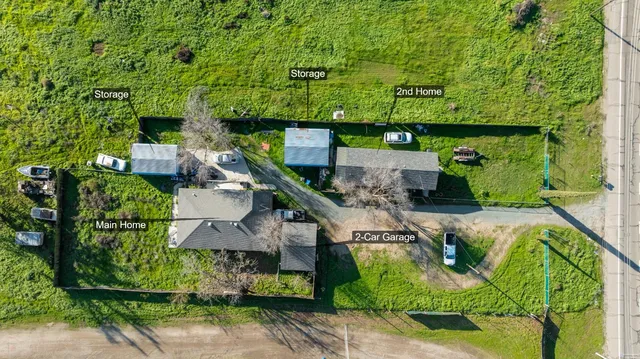 an outdoor space with seating area and trees in the background
