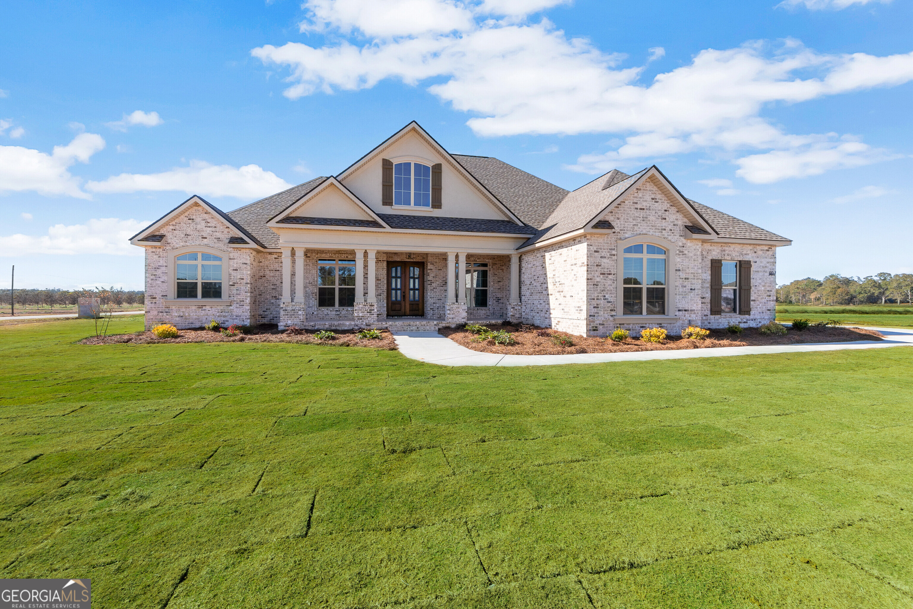 0 Pridgen Pass Perry, GA 31069 - Photo 2 of 4 a front view of a house with a yard table and chairs