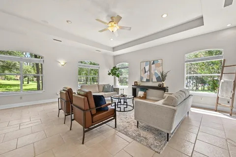 a living room with furniture and a large window