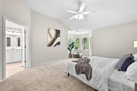 a bathroom with a tub a sink and mirror