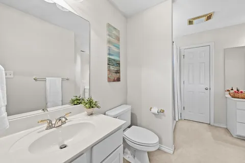 a bathroom with 2 sink tub and a mirror