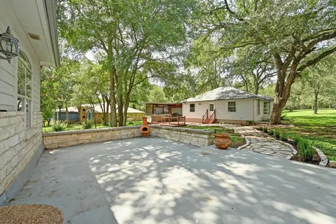 a view of a house with a yard and wooden deck