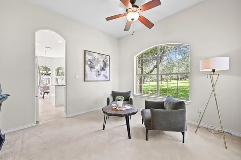 a living room with furniture and a large window