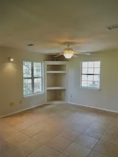 a view of an empty room with a chandelier