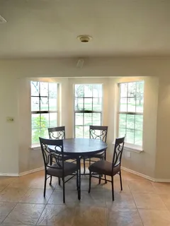 a kitchen with a table and chairs