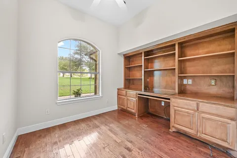 a room with a window and cabinets