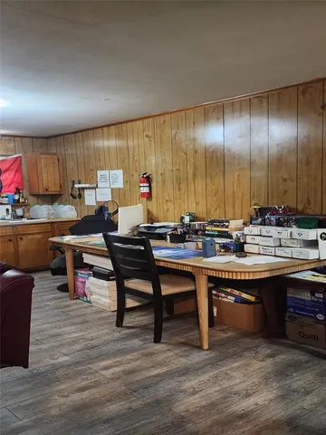 a living room with furniture a table and kitchen view