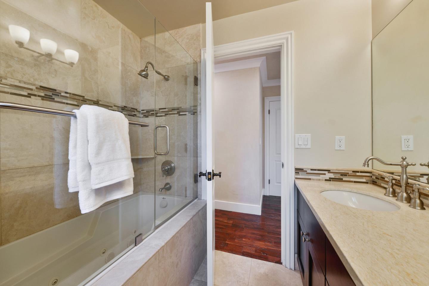 117 Worcester Loop Los Gatos, CA 95030 - Photo 28 of 47 a bathroom with a granite countertop sink mirror and shower