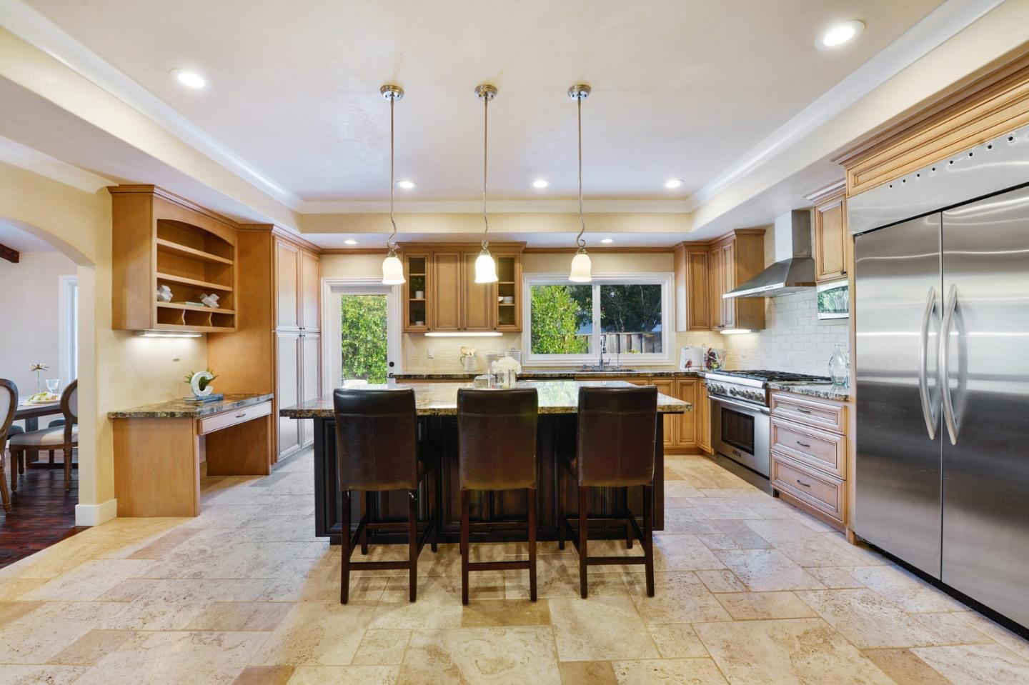 117 Worcester Loop Los Gatos, CA 95030 - Photo 29 of 47 a kitchen with stainless steel appliances granite countertop a refrigerator a sink a stove and a dining table with wooden floor
