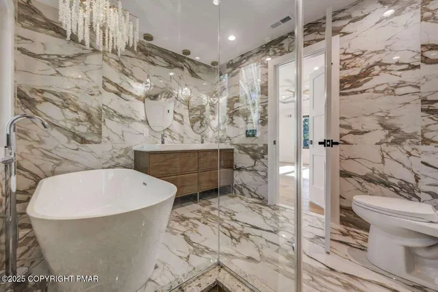 a bathroom with a toilet and shower