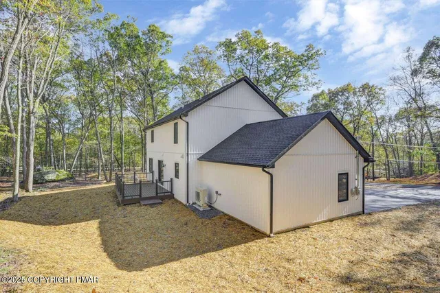 a view of a house with a yard covered with snow in the background
