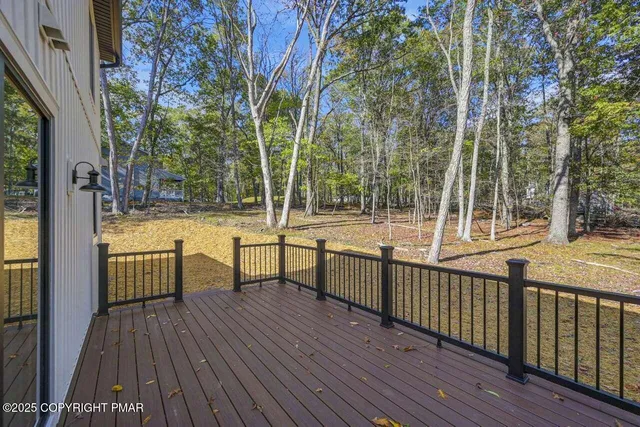 a view of a balcony with wooden floor and fence