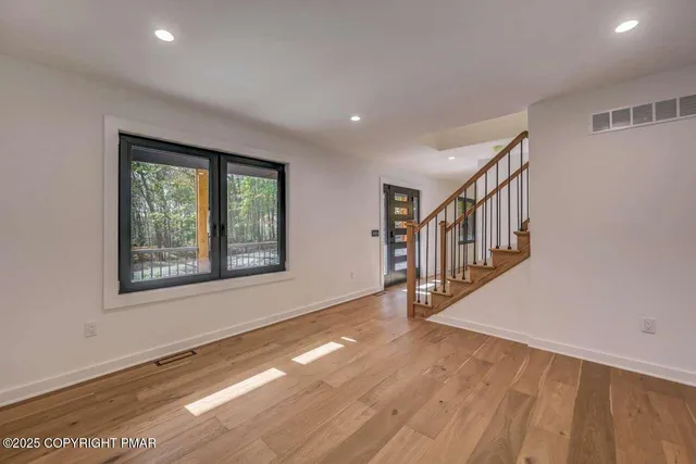 a view of an entryway with wooden floor