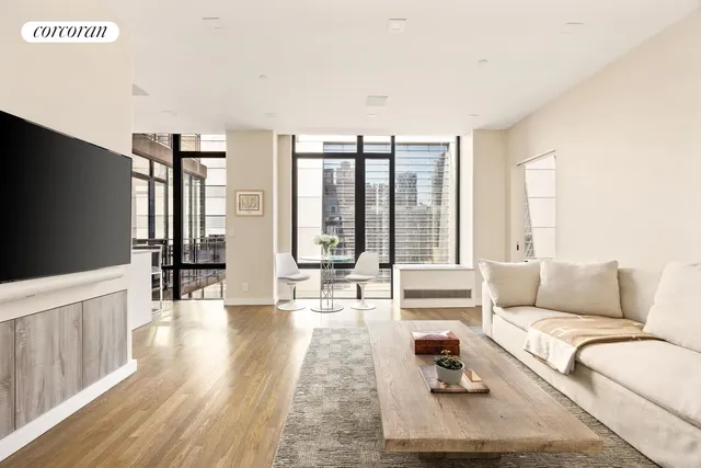 a living room with furniture and large windows