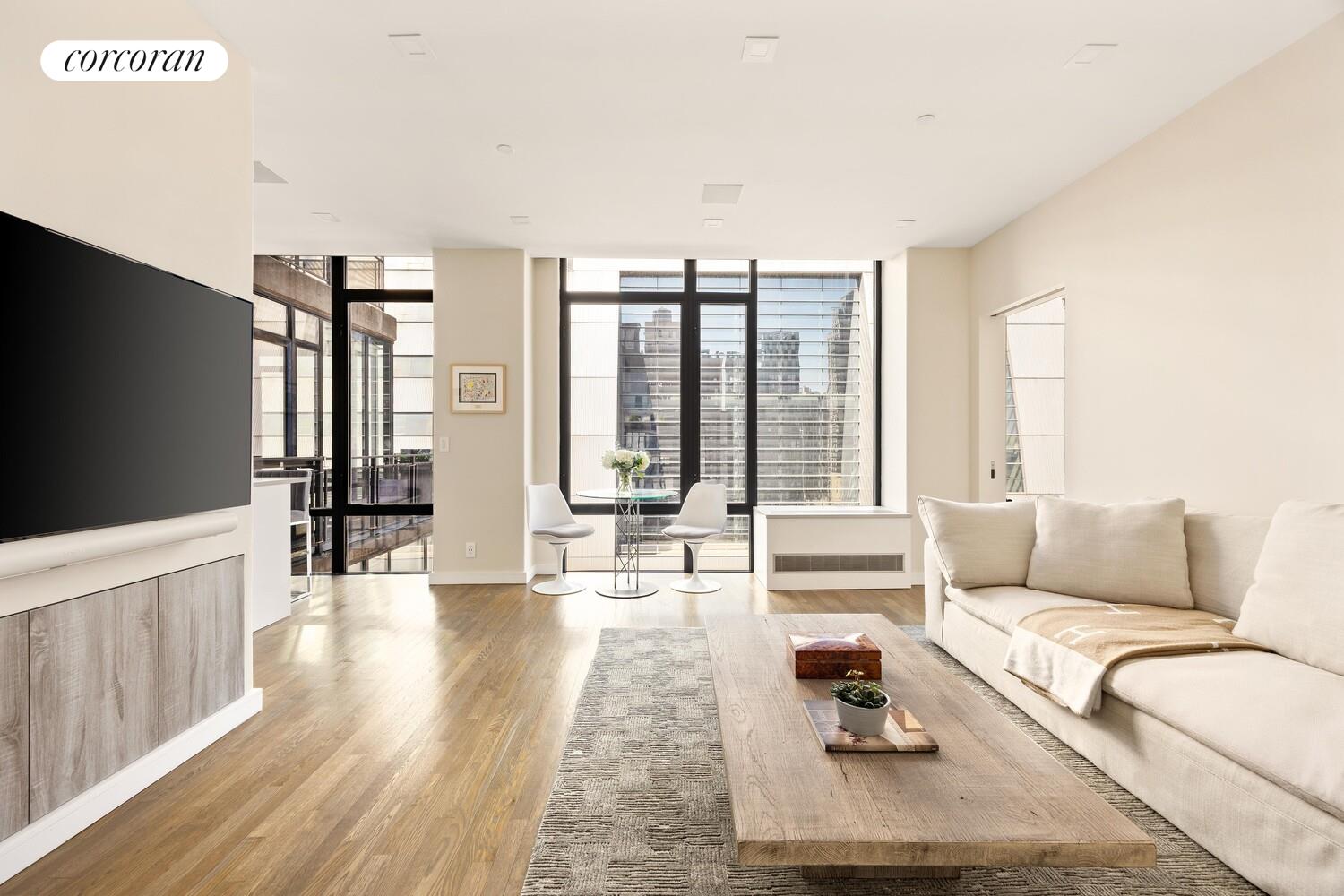 a living room with furniture and large windows