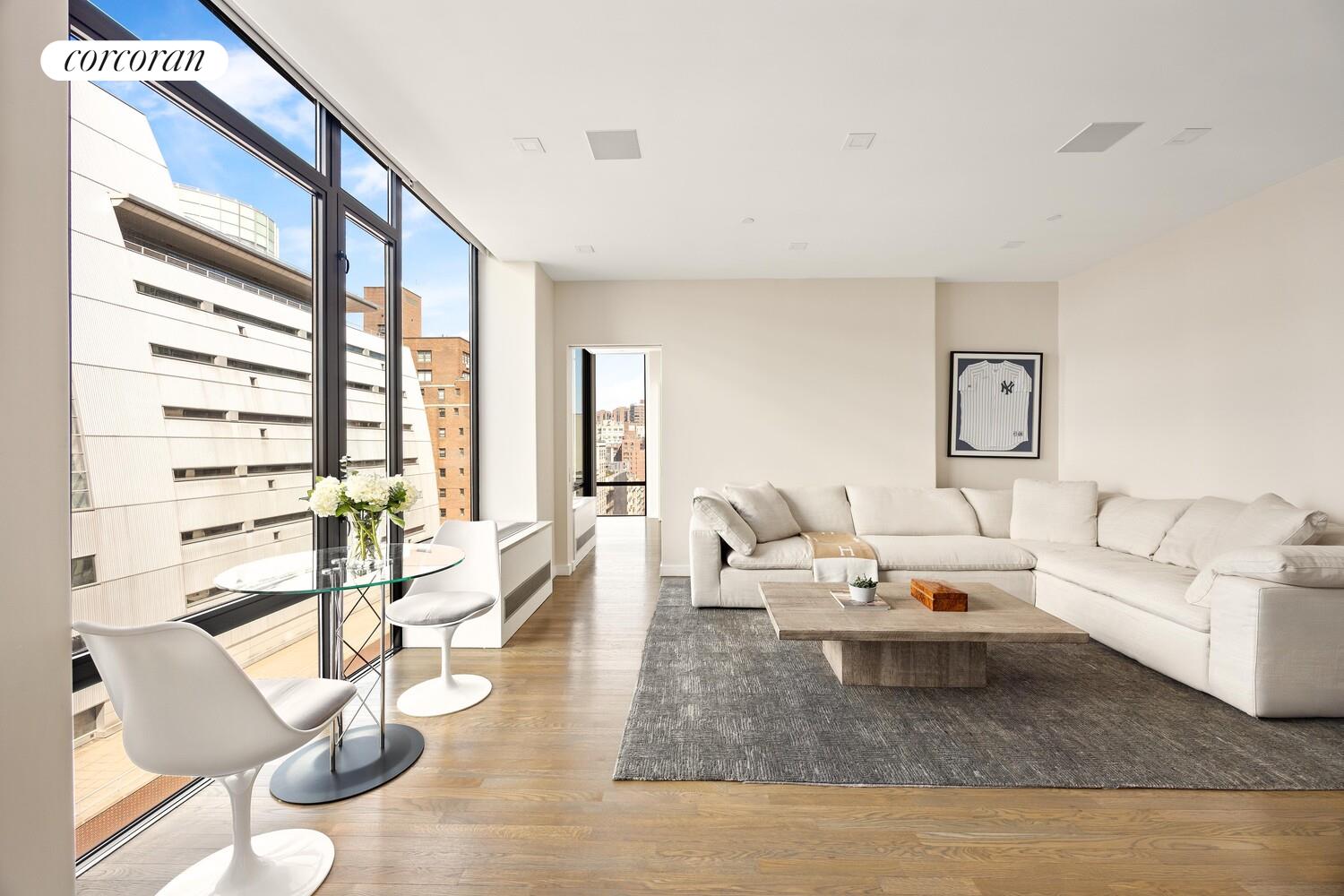 148 East 24th Street, Unit 15A Manhattan, NY 10010 - Photo 10 of 14 a living room with furniture and a large window