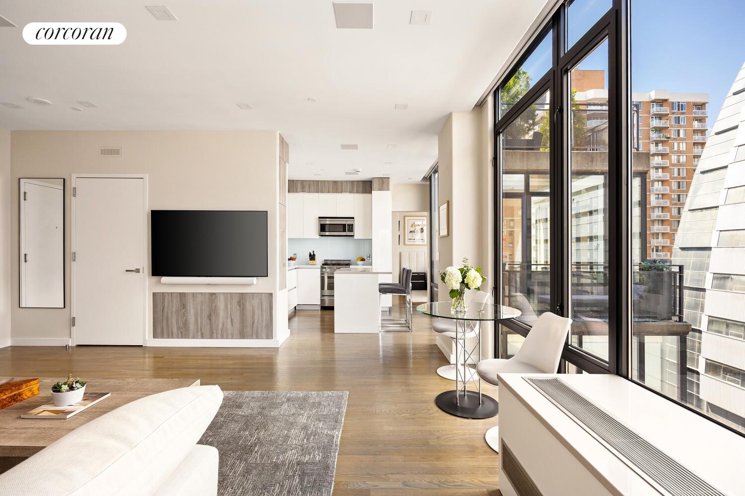 148 East 24th Street, Unit 15A Manhattan, NY 10010 - Photo 2 of 14 a living room with furniture and a flat screen tv