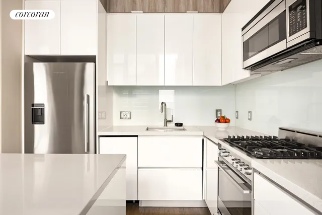 a kitchen with kitchen island wooden cabinets and refrigerator