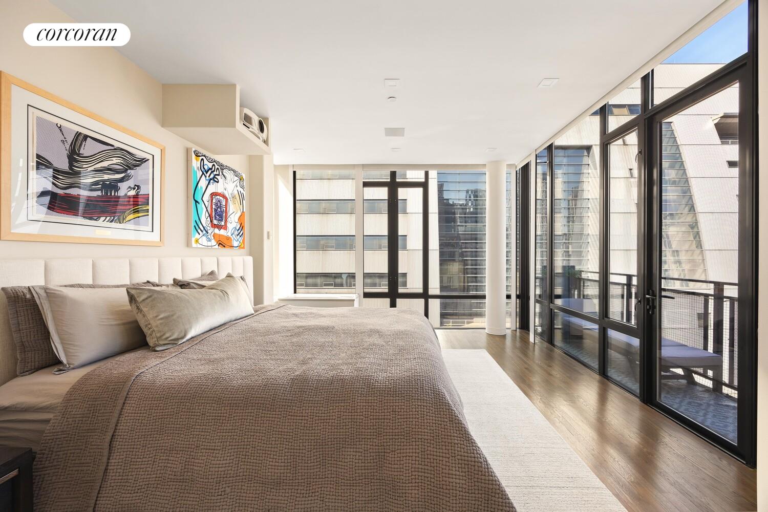 148 East 24th Street, Unit 15A Manhattan, NY 10010 - Photo 6 of 14 a spacious bedroom with a large bed and a large window