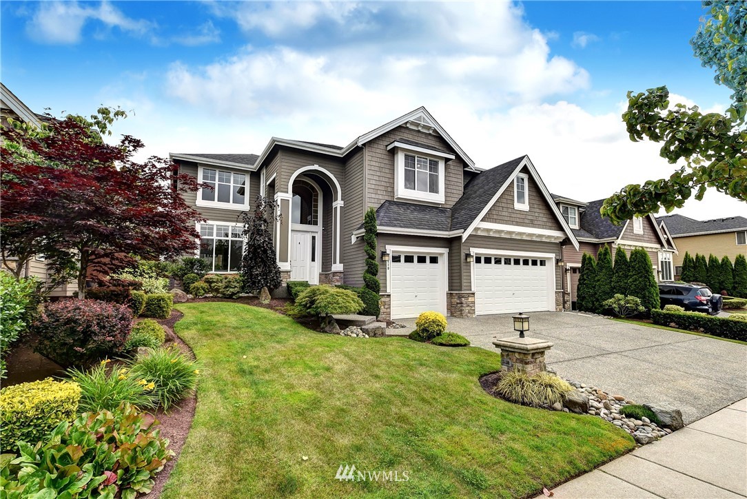 4410 220th Street Southeast Bothell, WA 98021 - Photo 2 of 28 a front view of a house with a yard and garage