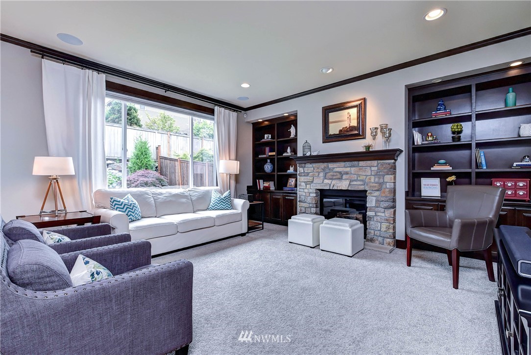 4410 220th Street Southeast Bothell, WA 98021 - Photo 12 of 28 a living room with furniture and a fireplace