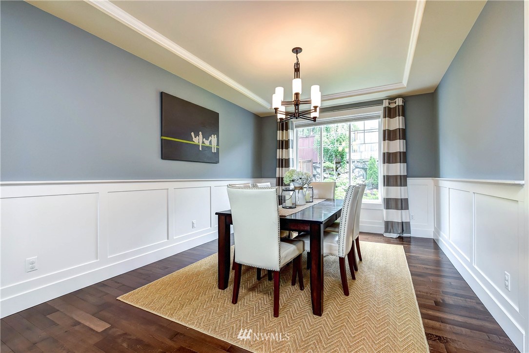 4410 220th Street Southeast Bothell, WA 98021 - Photo 13 of 28 a view of a dining room with furniture and wooden floor
