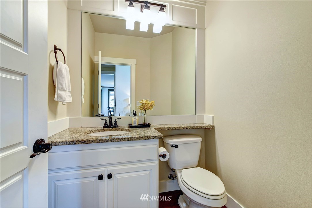 4410 220th Street Southeast Bothell, WA 98021 - Photo 16 of 28 a bathroom with a granite countertop toilet sink and mirror