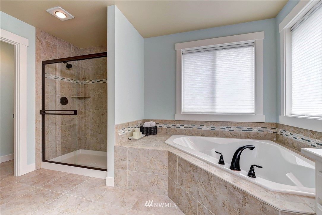 4410 220th Street Southeast Bothell, WA 98021 - Photo 20 of 28 a bathroom with a tub a window and a shower