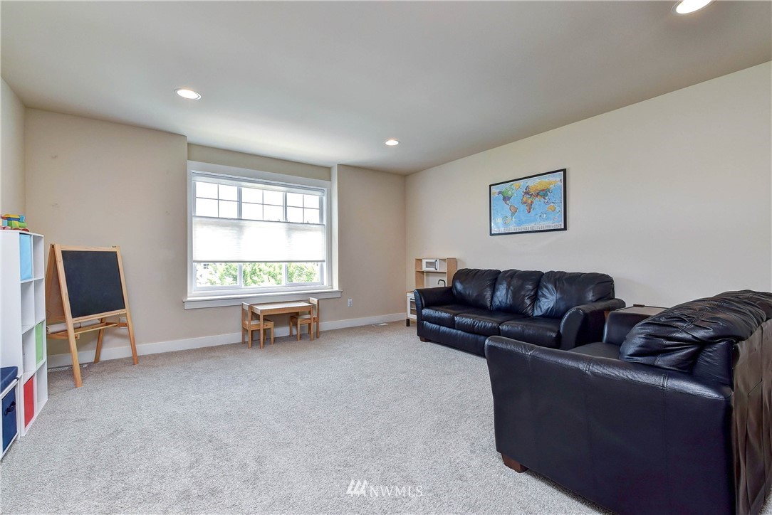 4410 220th Street Southeast Bothell, WA 98021 - Photo 21 of 28 a living room with furniture and a flat screen tv
