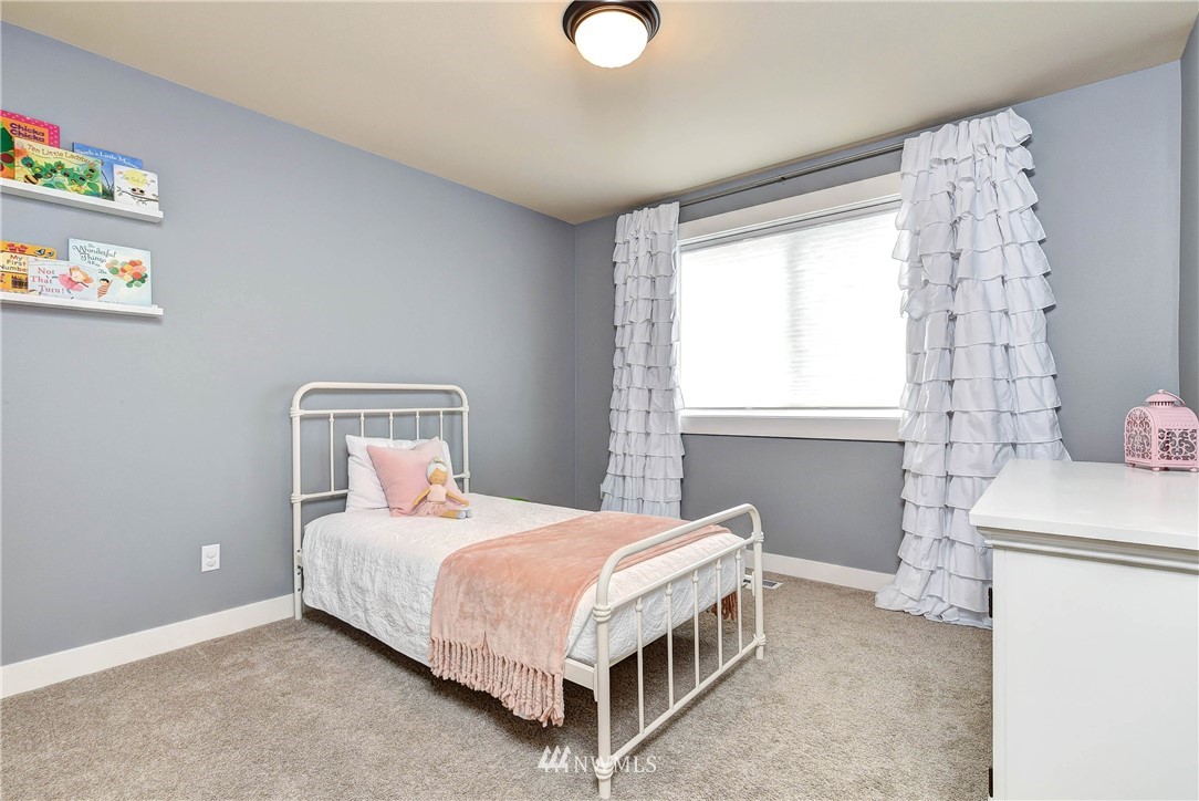 4410 220th Street Southeast Bothell, WA 98021 - Photo 23 of 28 a bedroom with a bed and a window