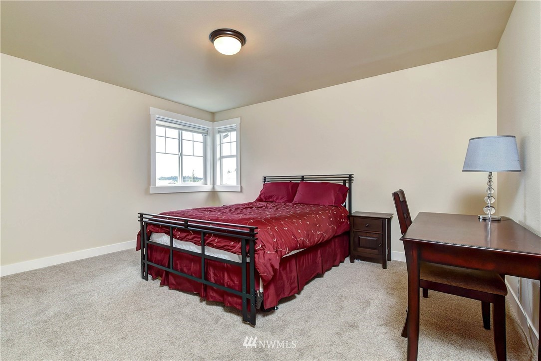 4410 220th Street Southeast Bothell, WA 98021 - Photo 24 of 28 a bed room with a bed and a desk