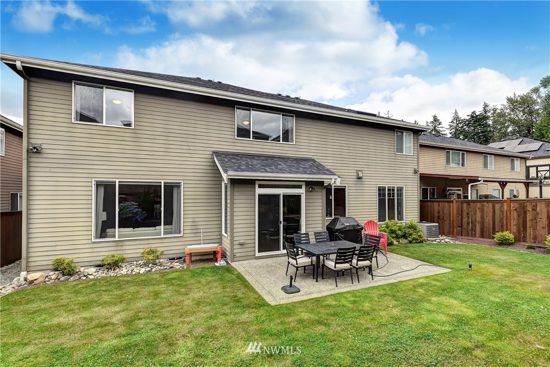 4410 220th Street Southeast Bothell, WA 98021 - Photo 27 of 28 a backyard of a house with table and chairs
