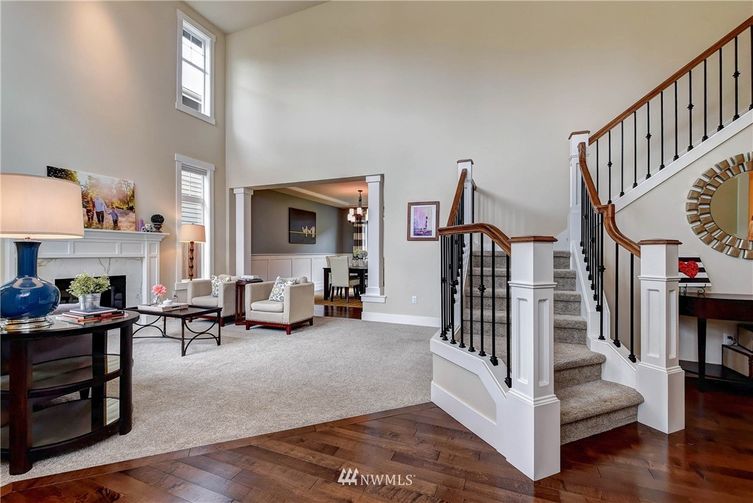 4410 220th Street Southeast Bothell, WA 98021 - Photo 4 of 28 a living room with furniture stairs and a fireplace
