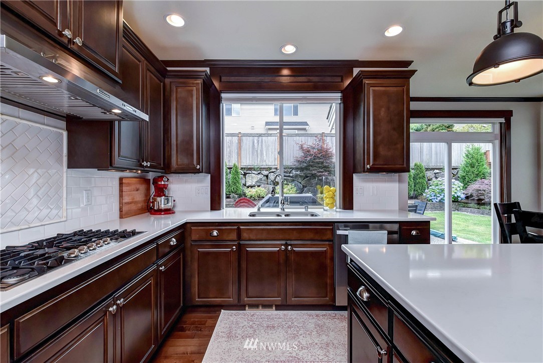 4410 220th Street Southeast Bothell, WA 98021 - Photo 9 of 28 a kitchen with stainless steel appliances a sink stove and cabinets