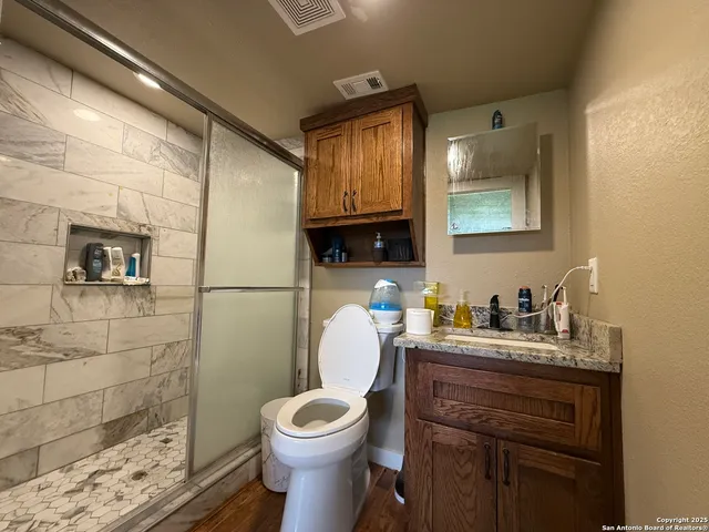 a bathroom with a toilet sink and mirror