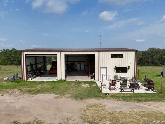 a view of a house with backyard sitting area and garden