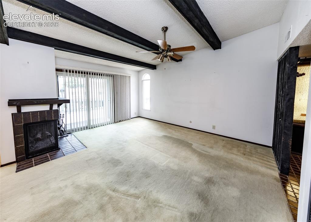 1034 Fontmore Road, Unit D Colorado Springs, CO 80904 - Photo 11 of 43 a view of an empty room with a fireplace