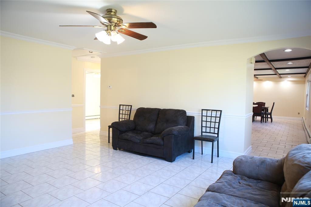 2 Harvey Avenue, Unit A Rochelle Park, NJ 07662 - Photo 12 of 25 a living room with furniture and a chandelier