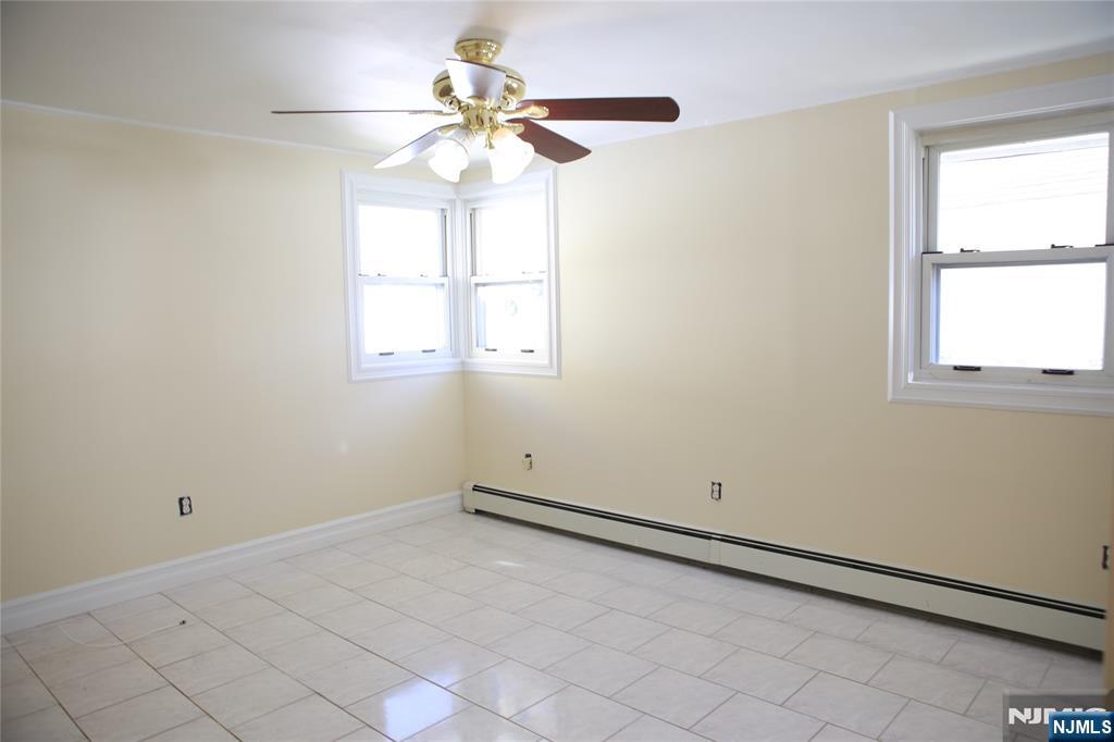 2 Harvey Avenue, Unit A Rochelle Park, NJ 07662 - Photo 21 of 25 an empty room with a window and a fan
