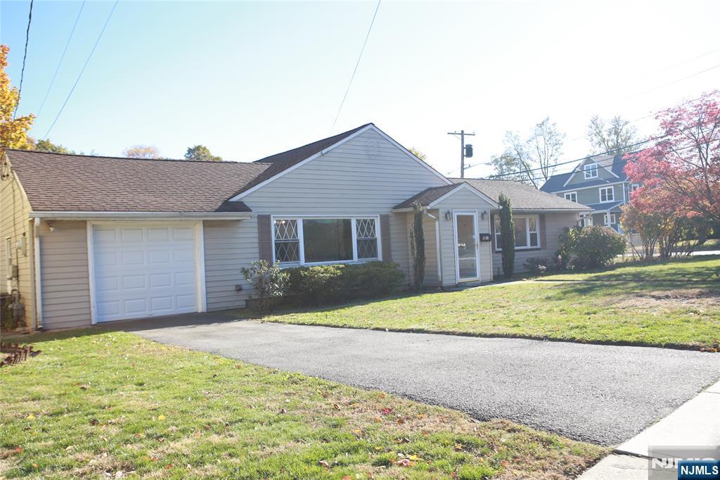 2 Harvey Avenue, Unit A Rochelle Park, NJ 07662 - Photo 23 of 25 a front view of a house with a yard and garage
