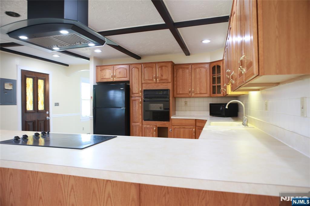 2 Harvey Avenue, Unit A Rochelle Park, NJ 07662 - Photo 6 of 25 a view of kitchen with stainless steel appliances kitchen island granite countertop a refrigerator and a sink