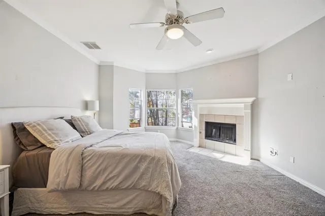 a spacious bedroom with a bed and a fireplace