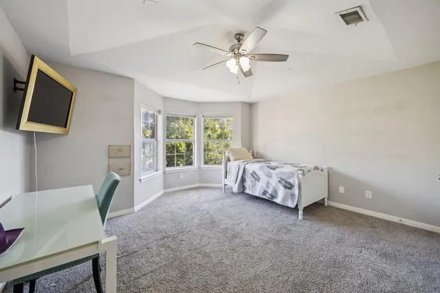 a bed room with a bed and a television