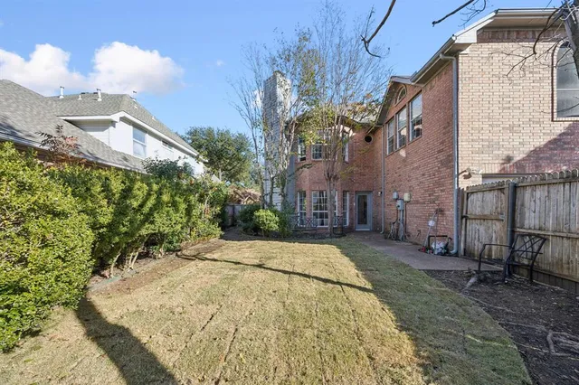 a view of a garden with a building in the background