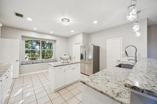 a kitchen with a refrigerator a sink and a stove