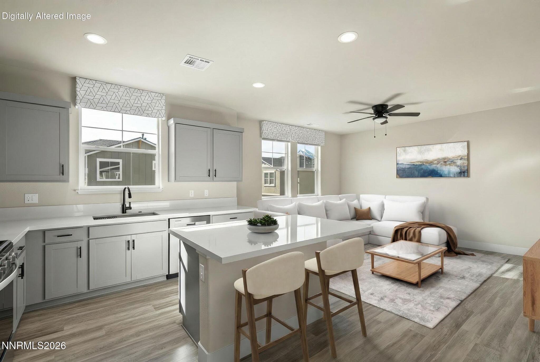 a kitchen with a sink cabinets and wooden floor